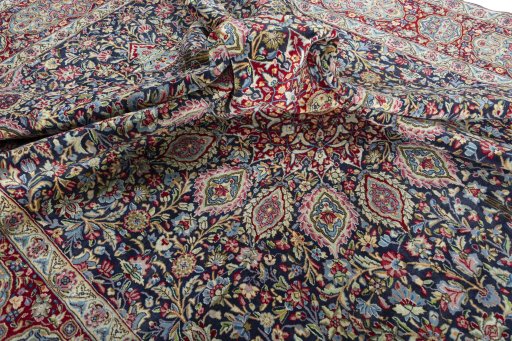 Surface texture of 2000s Kerman rug with natural Wool and intricate pattern