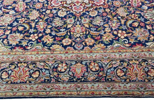 Corner detail of 2000s Kerman rug showing border pattern and Wool pile
