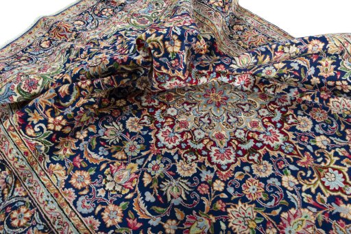 Surface texture of 2000s Kerman rug with natural Wool and intricate pattern