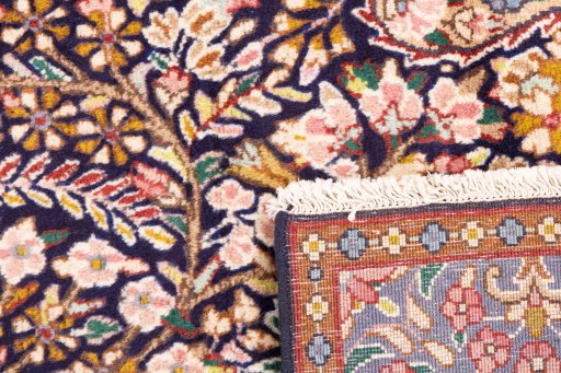 Close-up detail of 1980s Kerman rug from Iran / Persia showing Wool weave