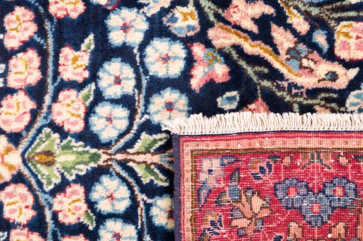 Close-up detail of 1970s Kerman rug from Iran / Persia showing Wool weave