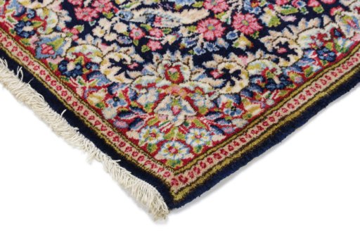 Backside of handmade 1990s Kerman rug showing knot structure and weave density