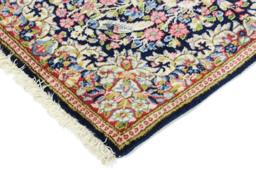 Backside of handmade 1990s Kerman rug showing knot structure and weave density