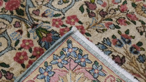 Close-up detail of 1920s Kerman rug from Iran / Persia showing Wool weave
