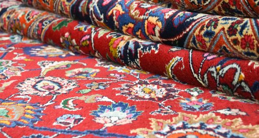 Full view of 1960s Mashad rug from Iran / Persia, 500 × 345 cm in Dark red tones