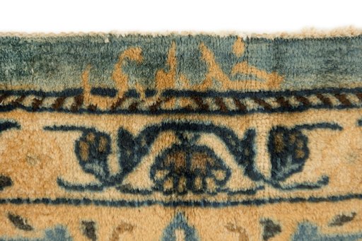 Backside of handmade 1980s Mashad rug showing knot structure and weave density