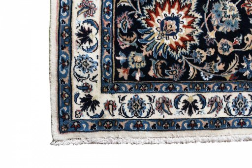 Backside of handmade New Mashad rug showing knot structure and weave density