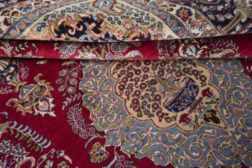 Surface texture of 1970s Mashad rug with natural Wool and intricate pattern