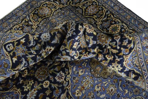 Surface texture of 2000s Mashad rug with natural Wool and intricate pattern