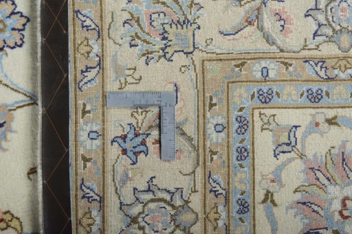 Backside of handmade New Mashad rug showing knot structure and weave density