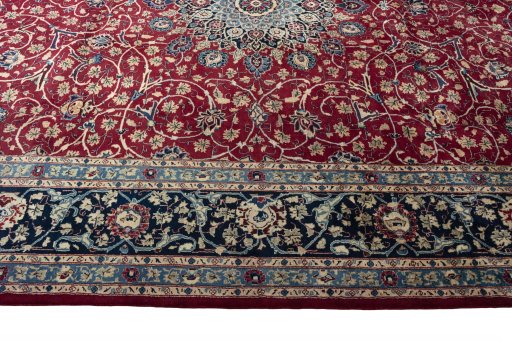 Corner detail of 2000s Mashad rug showing border pattern and Wool pile