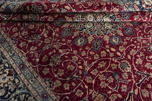 Surface texture of 2000s Mashad rug with natural Wool and intricate pattern