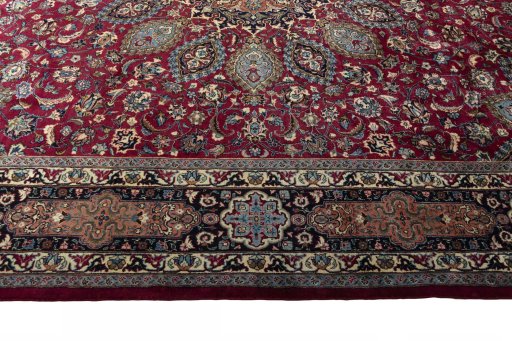 Corner detail of 2000s Mashad rug showing border pattern and Wool pile
