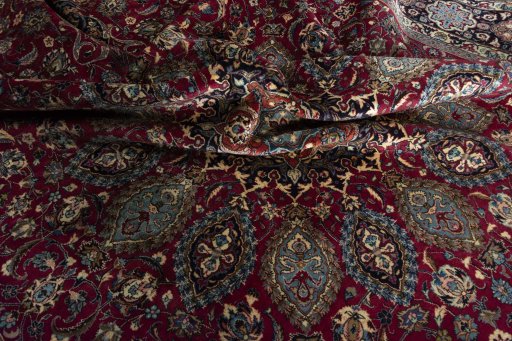 Surface texture of 2000s Mashad rug with natural Wool and intricate pattern