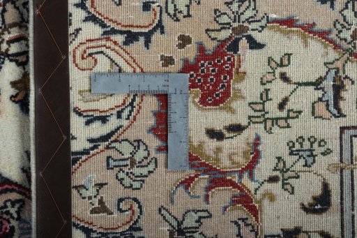 Backside of handmade New Mashad rug showing knot structure and weave density