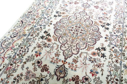 Backside of handmade New Mashad rug showing knot structure and weave density