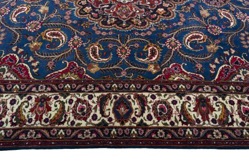 Corner detail of 2000s Mashad rug showing border pattern and Wool pile