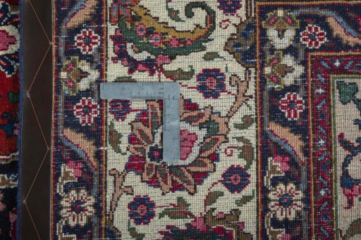 Backside of handmade 2000s Mashad rug showing knot structure and weave density