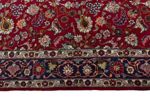 Corner detail of 2000s Mashad rug showing border pattern and Wool pile