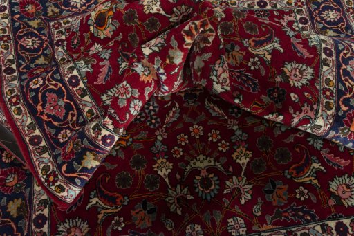 Surface texture of 2000s Mashad rug with natural Wool and intricate pattern