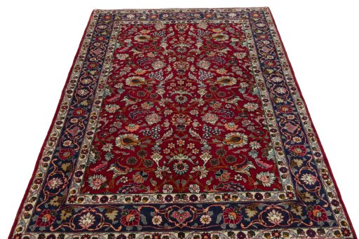 Surface texture of 2000s Mashad rug with natural Wool and intricate pattern