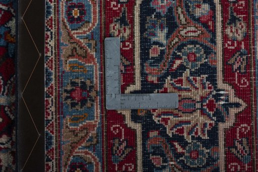 Backside of handmade 1970s Mashad rug showing knot structure and weave density