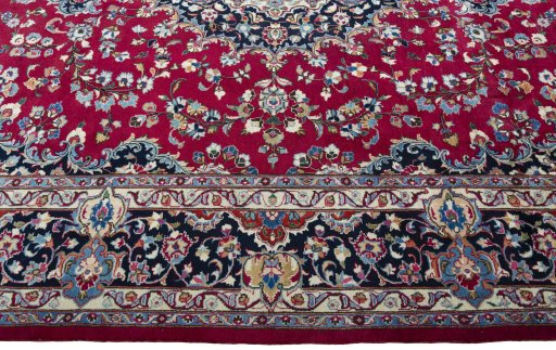 Corner detail of 2000s Mashad rug showing border pattern and Wool pile