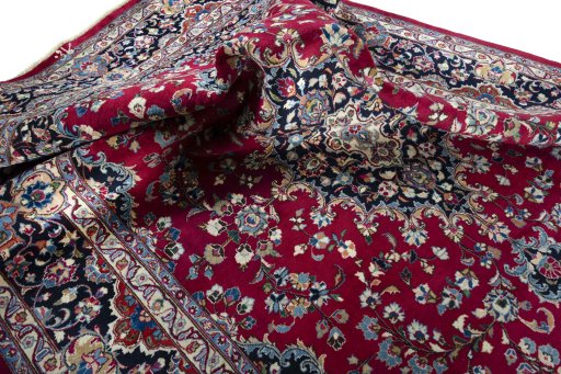 Surface texture of 2000s Mashad rug with natural Wool and intricate pattern