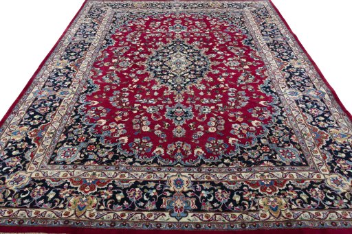 Surface texture of 2000s Mashad rug with natural Wool and intricate pattern