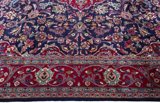 Corner detail of 2000s Mashad rug showing border pattern and Wool pile