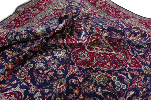 Surface texture of 2000s Mashad rug with natural Wool and intricate pattern
