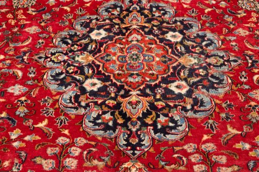 Corner detail of 2000s Mashad rug showing border pattern and Wool pile