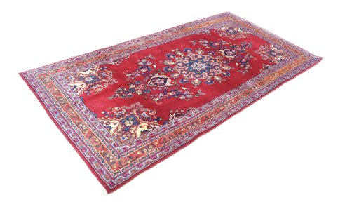 Corner detail of 2000s Mashad rug showing border pattern and Wool pile