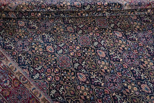 Corner detail of 1970s Moud rug showing border pattern and Wool pile