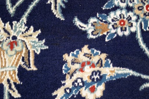 Backside of handmade 1990s Nain rug showing knot structure and weave density