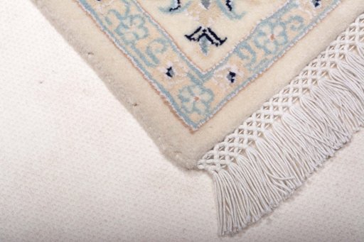 Backside of handmade New Nain rug showing knot structure and weave density