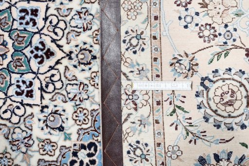 Backside of handmade New Nain rug showing knot structure and weave density