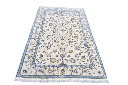 Surface texture of 2000s Nain rug with natural Wool and intricate pattern