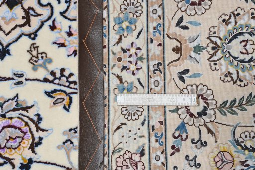 Backside of handmade New Nain rug showing knot structure and weave density
