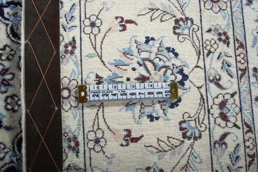 Backside of handmade New Nain rug showing knot structure and weave density