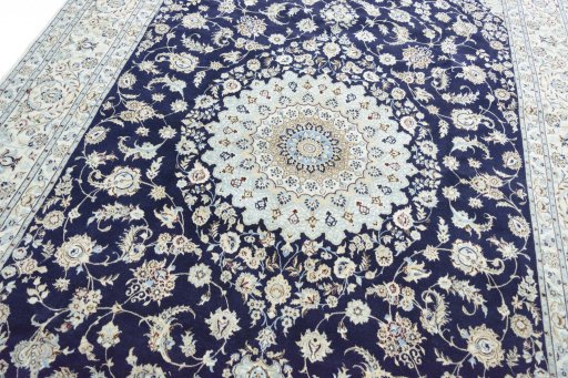 Backside of handmade New Nain rug showing knot structure and weave density