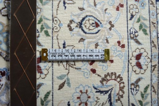 Backside of handmade New Nain rug showing knot structure and weave density