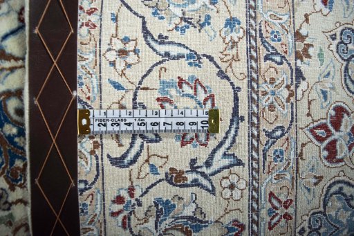 Backside of handmade New Nain rug showing knot structure and weave density