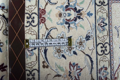 Backside of handmade New Nain rug showing knot structure and weave density