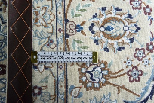 Backside of handmade New Nain rug showing knot structure and weave density