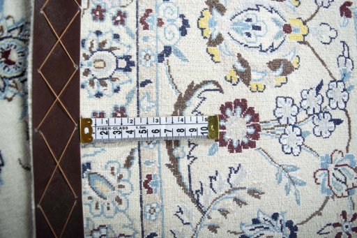 Backside of handmade New Nain rug showing knot structure and weave density
