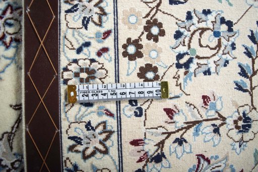 Backside of handmade New Nain rug showing knot structure and weave density