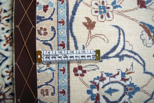 Backside of handmade New Nain rug showing knot structure and weave density