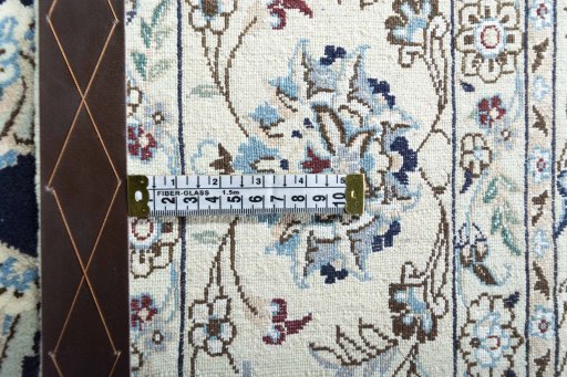 Backside of handmade New Nain rug showing knot structure and weave density