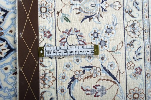 Backside of handmade New Nain rug showing knot structure and weave density